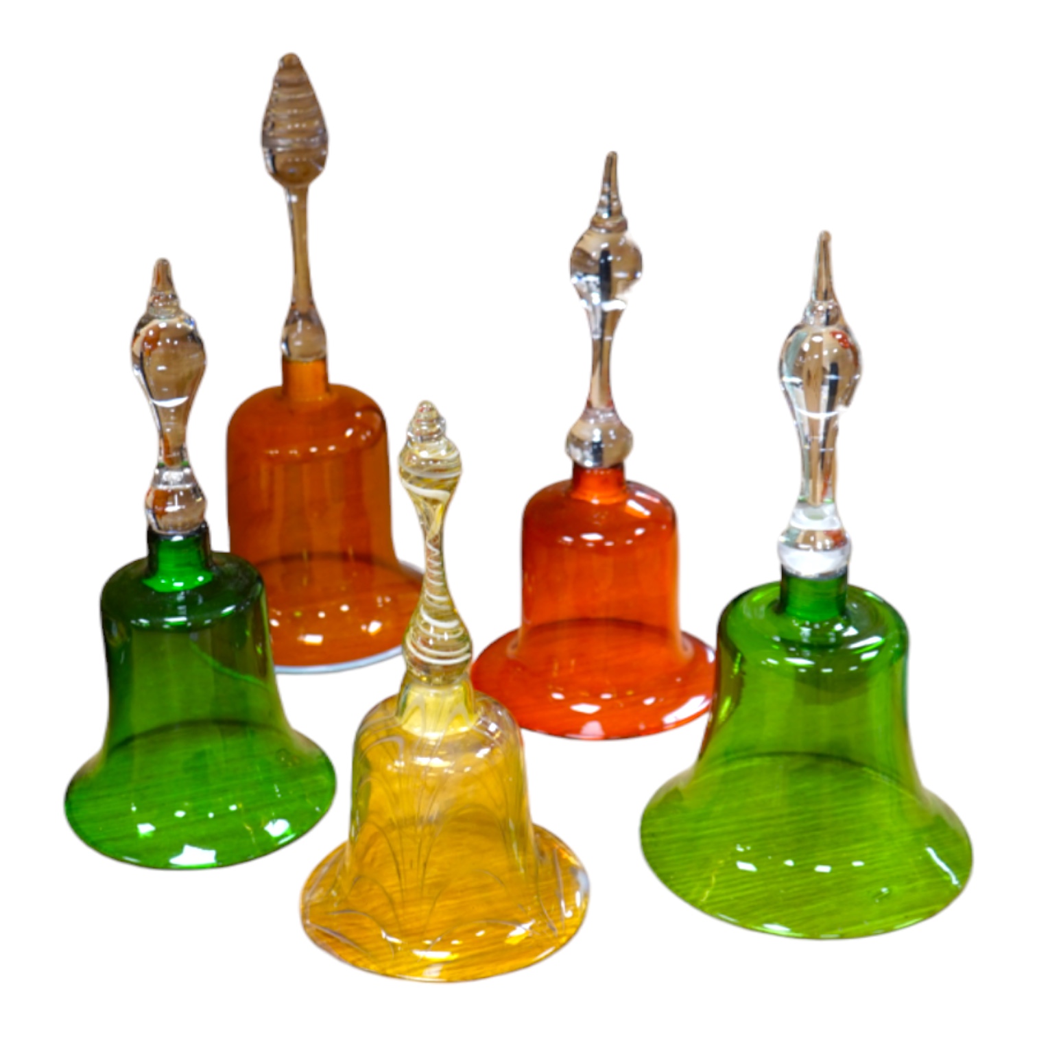 Five hand bells comprising an amber glass example with twist handle, two orange and two green glass hand bells, largest 36cm high. Condition - some repairs